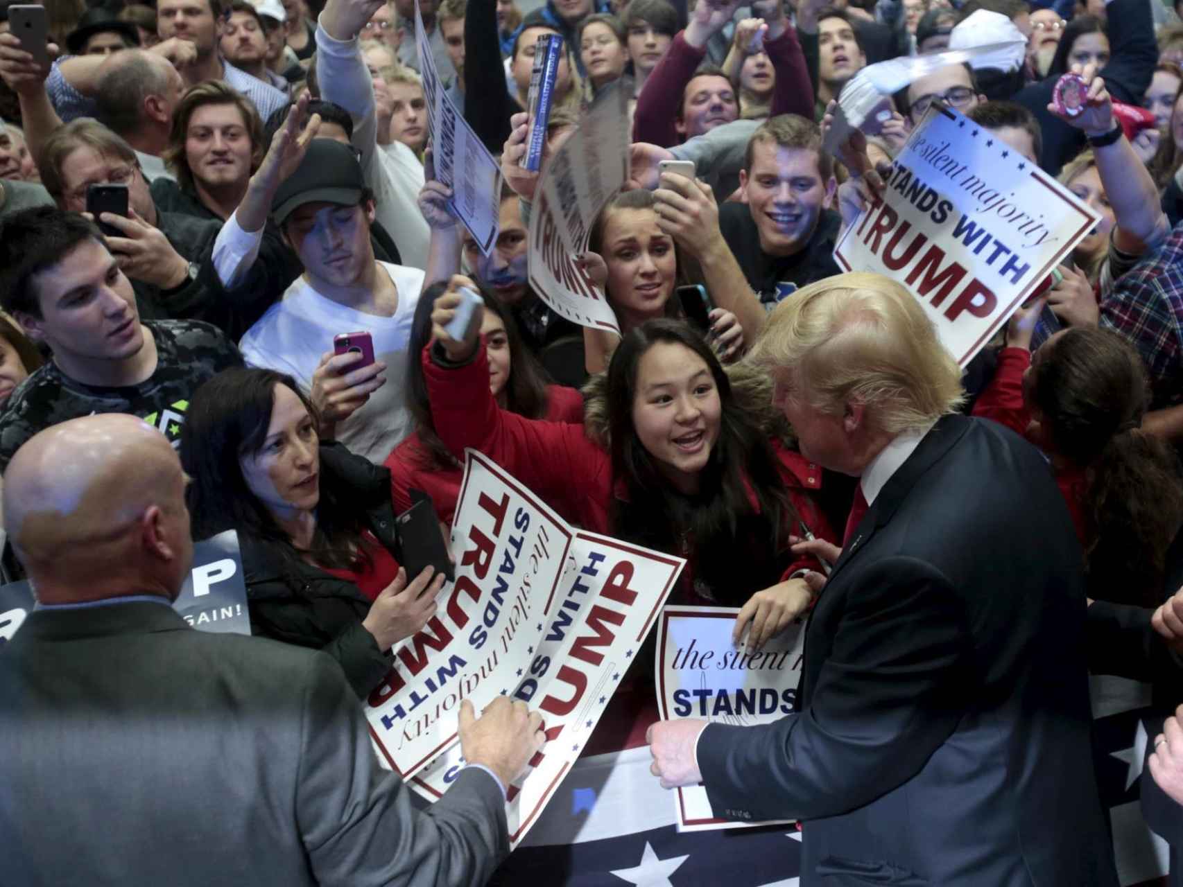 Trump se acerca a sus seguidores durante un acto electoral en Michigan.